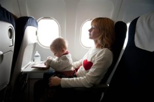 Baby on lap on plane.