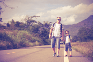 Father on son on a road trip with kids