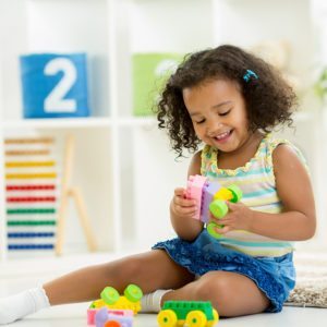 preschooler playing with duplo blocks