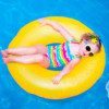Little Girl In Swimming Pool On Inflatable Ring