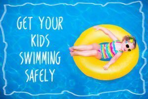 Little Girl In Swimming Pool On Inflatable Ring